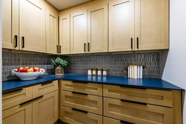 Pantry with bold Kir Royal quartz countertop in deep blue, paired with warm cabinetry.