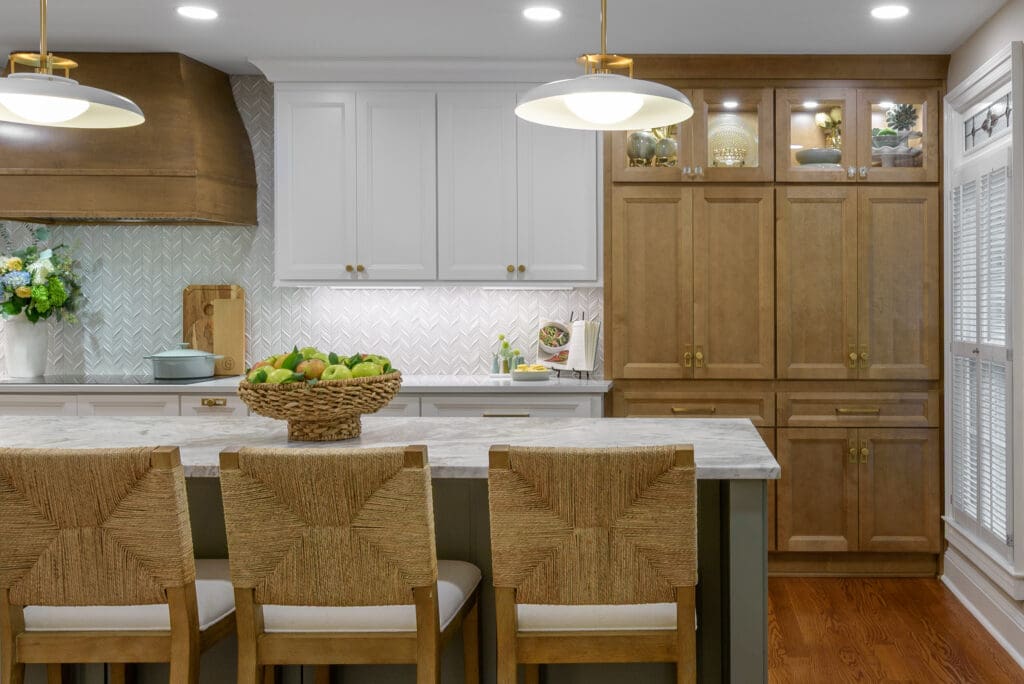 Seating area of Leathered Fantasy Brown Hard Marble islands with Brunello Quartz perimeter countertops in Marietta, GA kitchen.