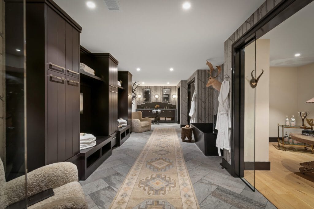 Wellness Suite dressing room with marble runner, dark cabinetry, and antler hooks in the Southeast Designer Showhouse 2026