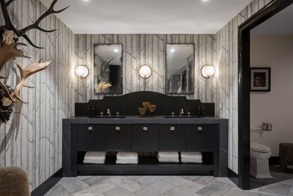 Wellness Center Liem Black porcelain vanity with antler decor and birch wallpaper in the Southeast Designer Showhouse 2026