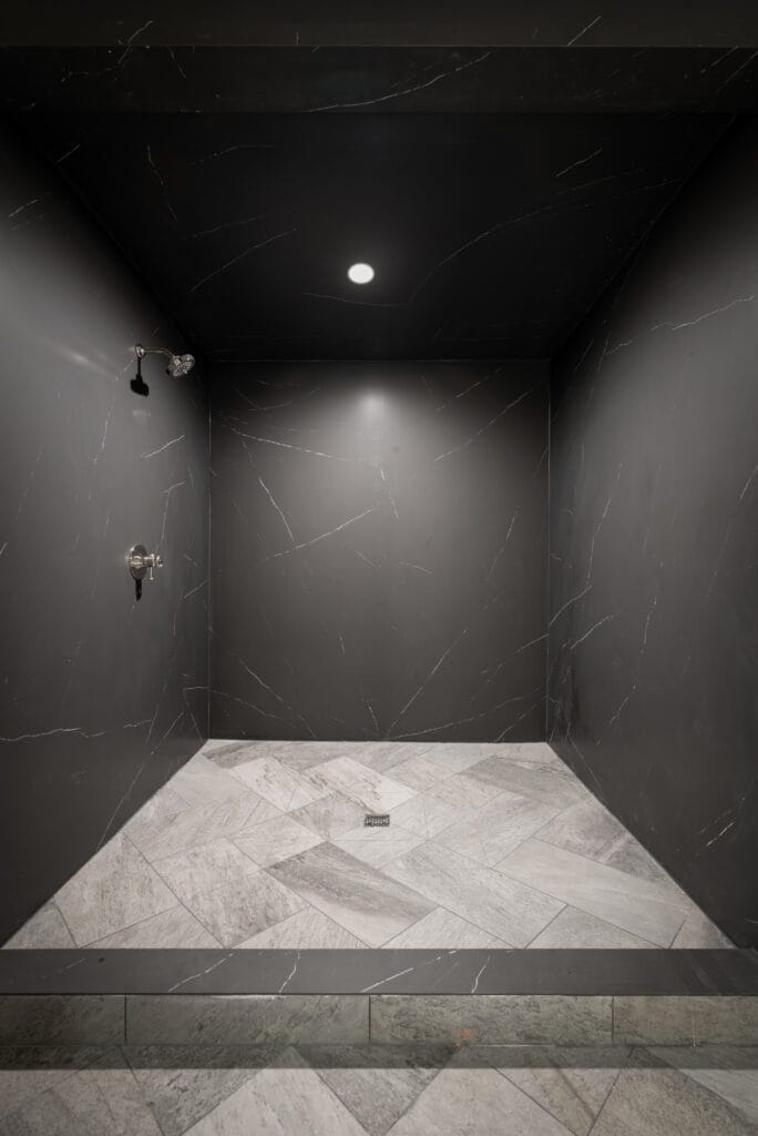 Liem Black porcelain walk-in shower with marble herringbone floor, Wellness Center, Southeast Designer Showhouse 2026