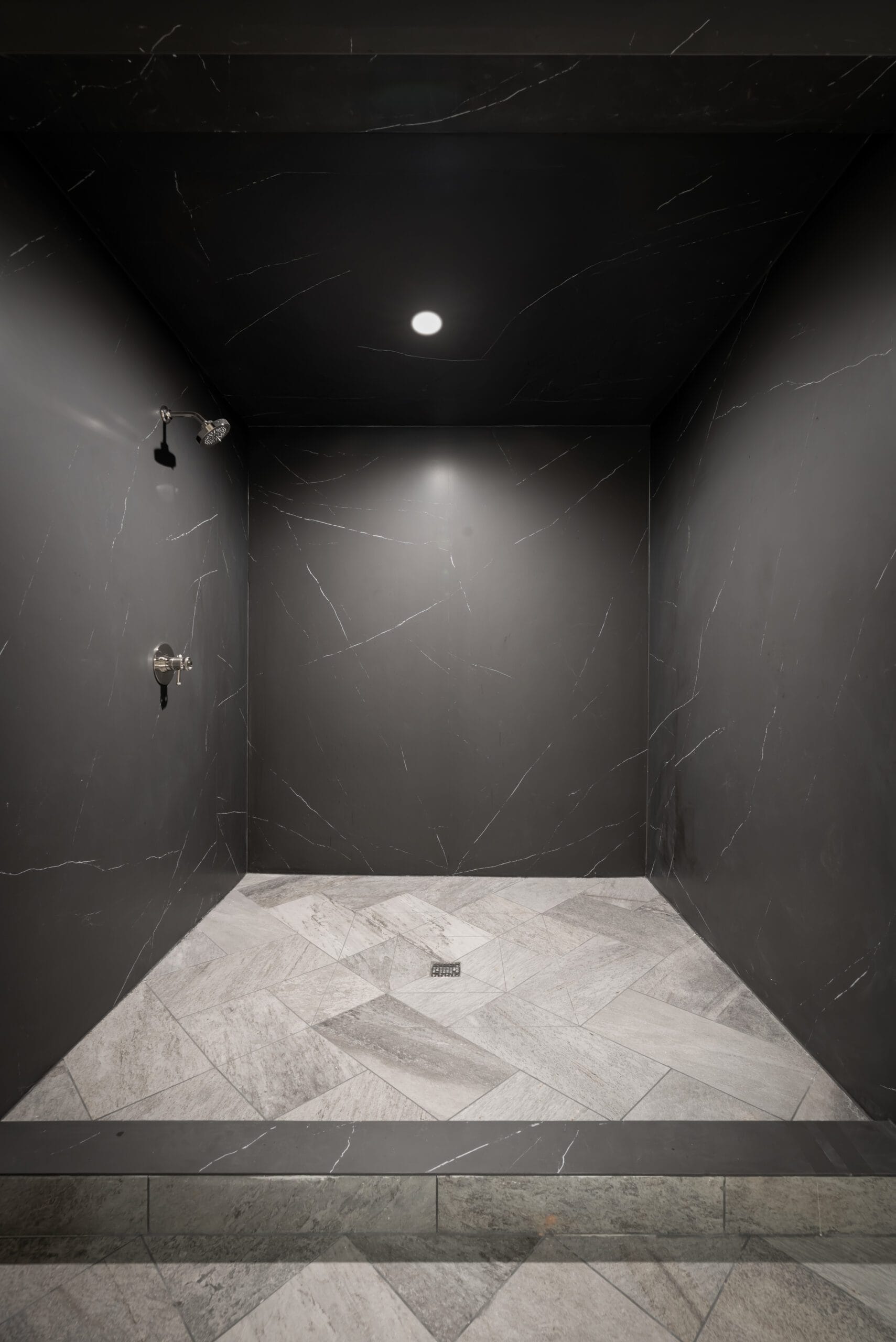 Liem Black porcelain walk-in shower with marble herringbone floor, Wellness Center, Southeast Designer Showhouse 2026