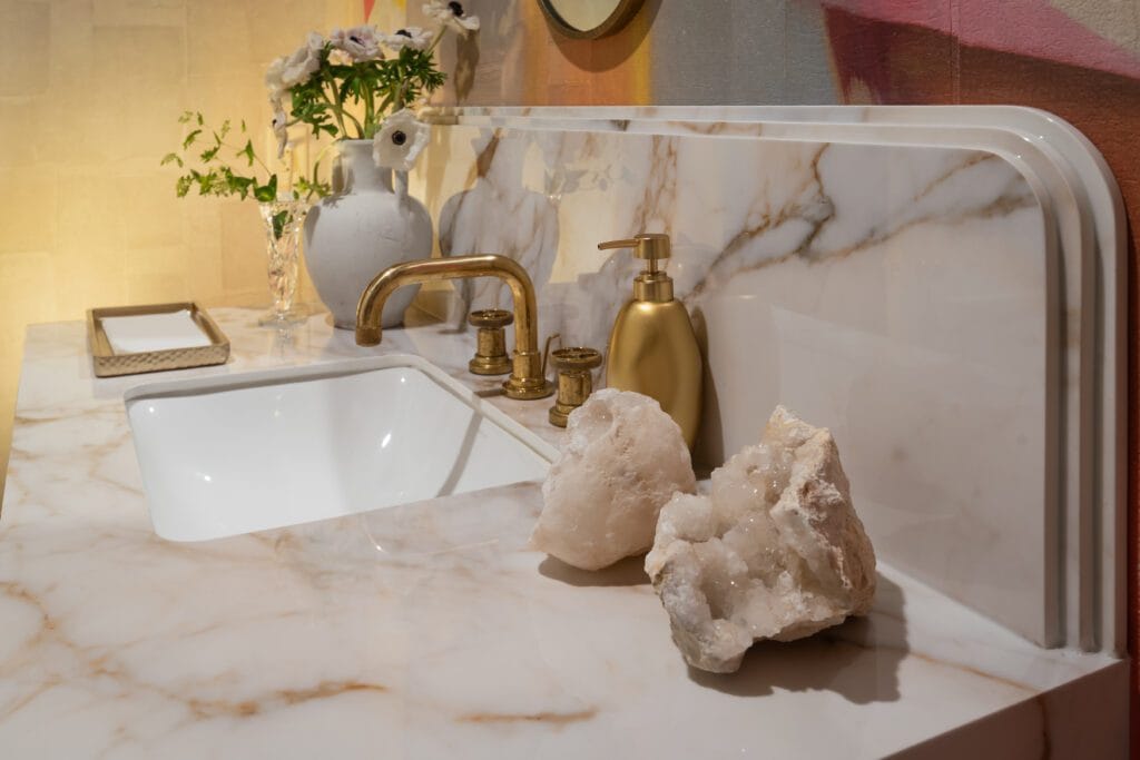 Art Deco Powder Room vanity with Calacatta Antico porcelain, brass fixtures, and warm tonal wallpaper, Southeast Designer Showhouse 2026