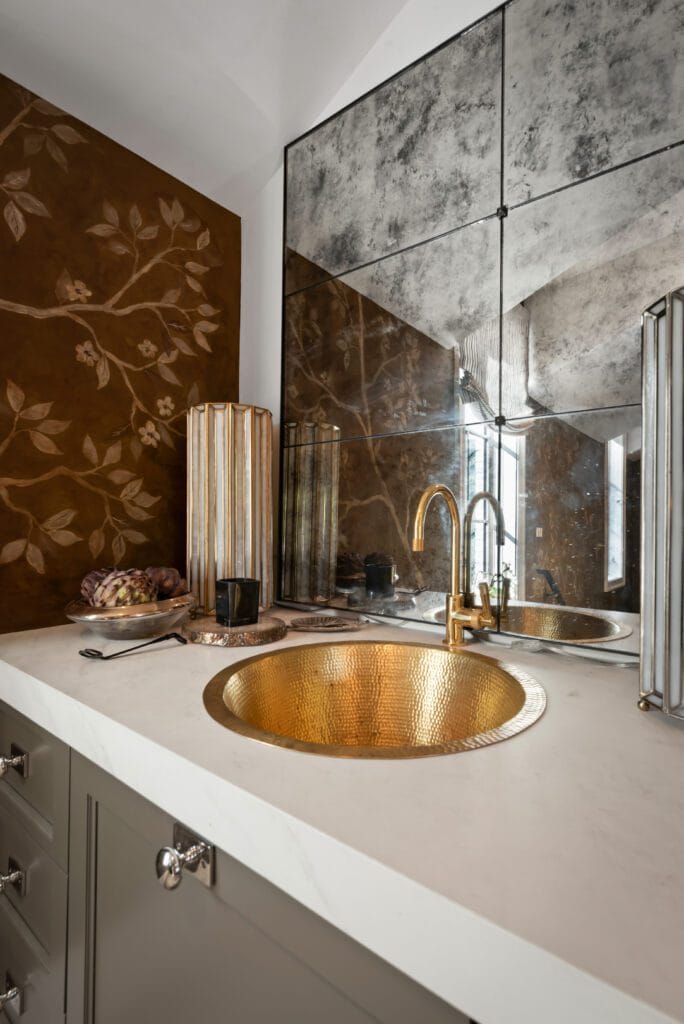 In-Law Suite vanity with hammered brass sink, white quartz countertop, and chinoiserie wallpaper, Southeast Designer Showhouse 2026