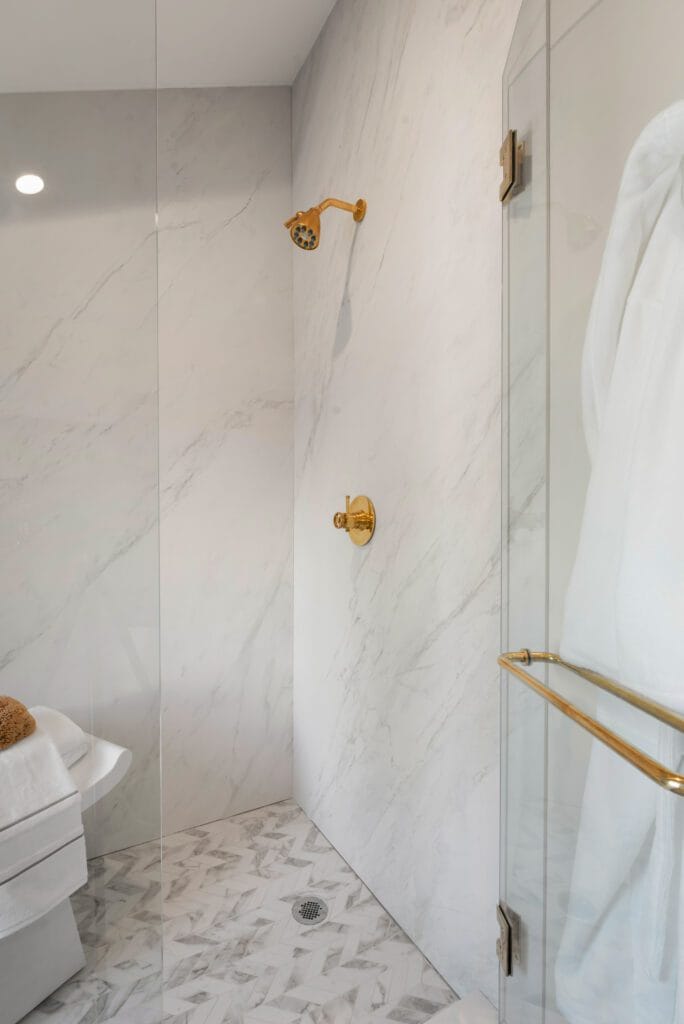 Marble shower detail with brass fixtures, In-Law Suite, Southeast Designer Showhouse 2026